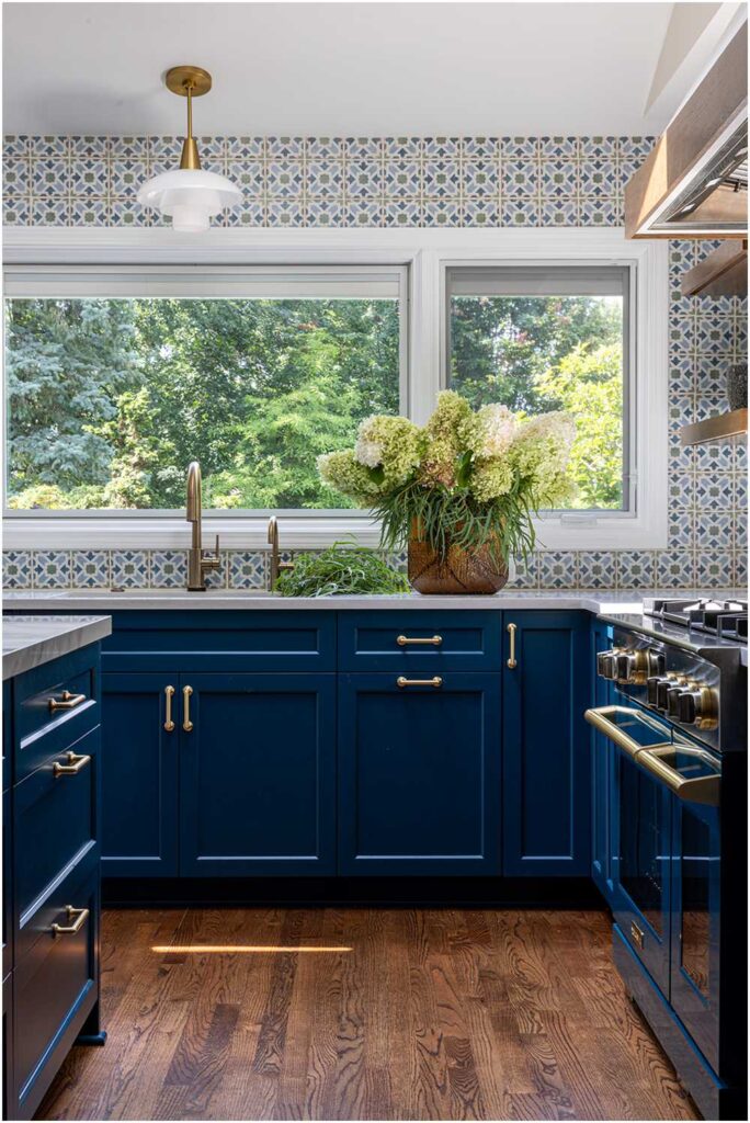 Hinsdale Kitchen Interior Design Blue cabinets with large picture window overlooking backyard
