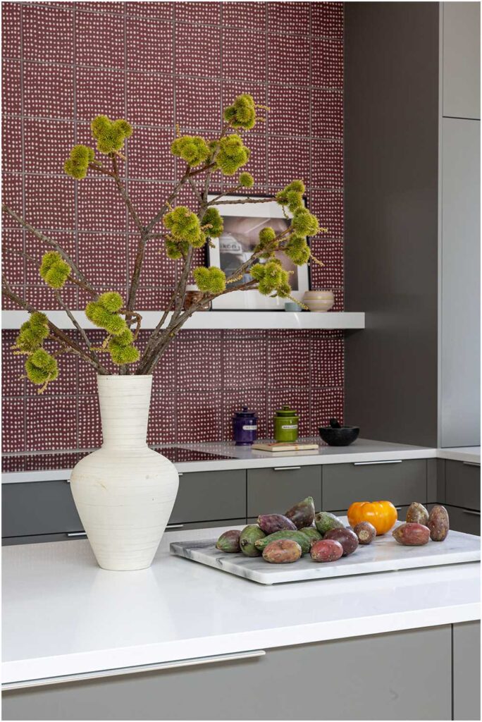 Midcentury modern kitchen with grey cabinetry and red tile backsplash — interior design photography for designers