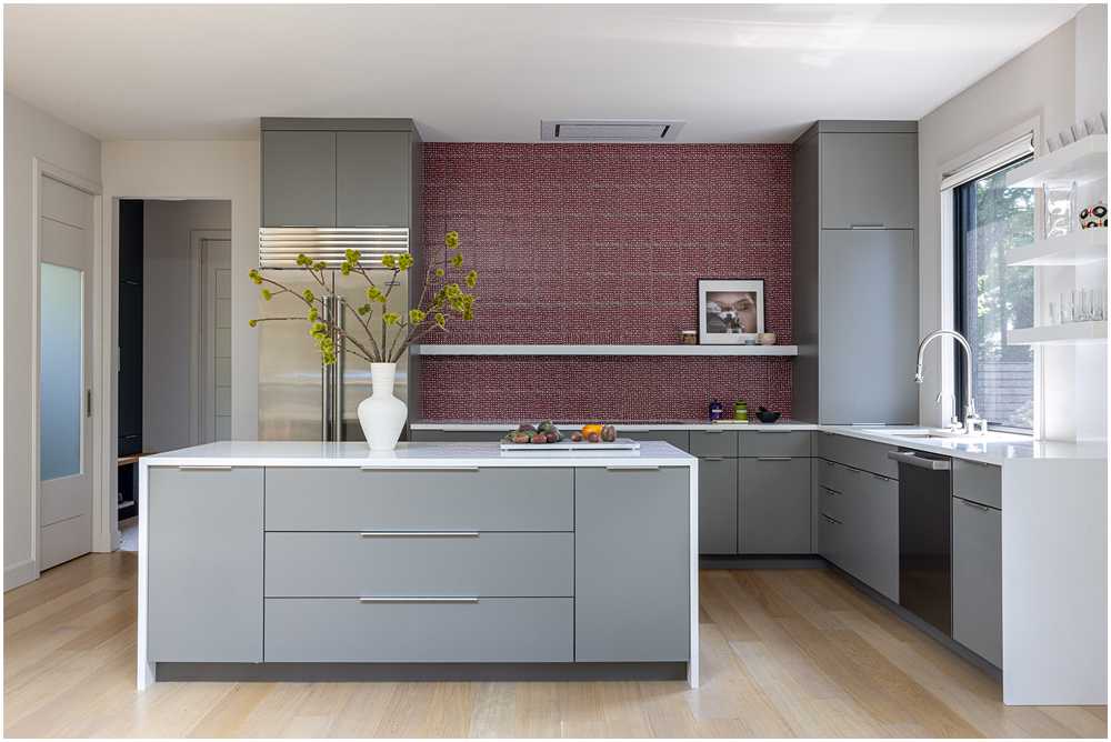 Midcentury modern kitchen with grey cabinetry and red tile backsplash — interior design photography for designers