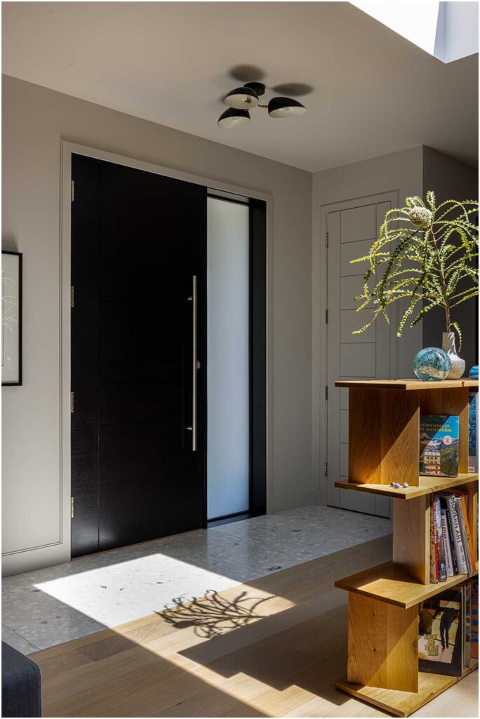 midcentury modern entryway with freestanding bookshelf — interior design photography for designers